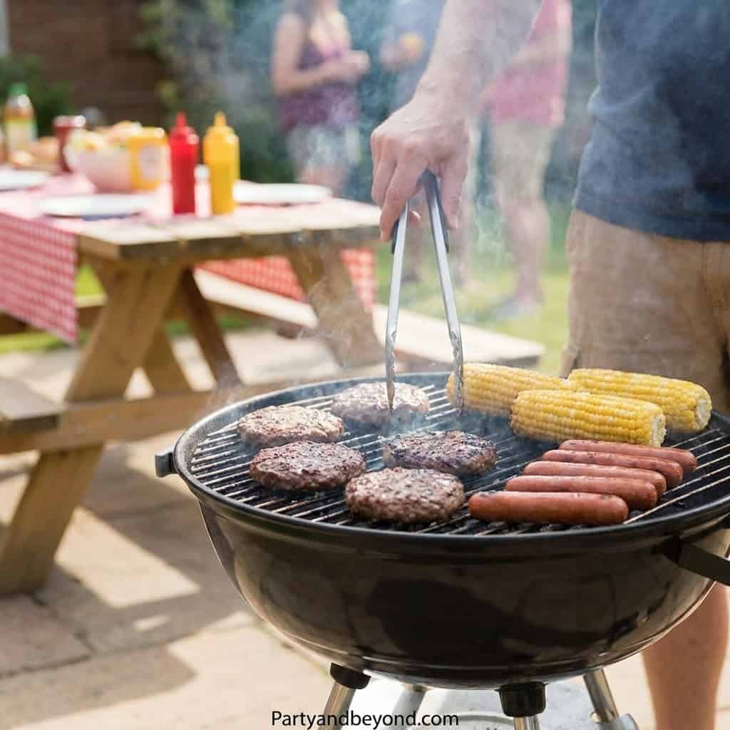 Man grilling burgers, hot dogs, and corn at outdoor graduation celebration.