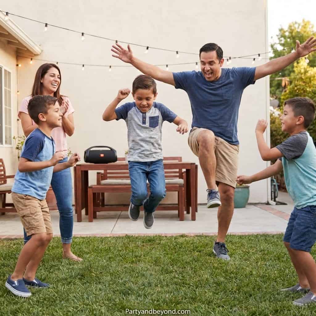 Kids and adults enjoying a lively outdoor party with jumping games and dancing in a backyard setting.