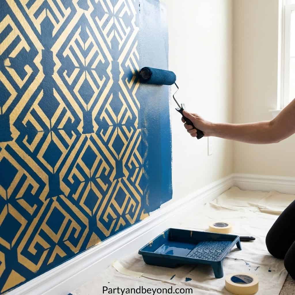 Person painting a blue geometric wall pattern for stylish DIY party decor.