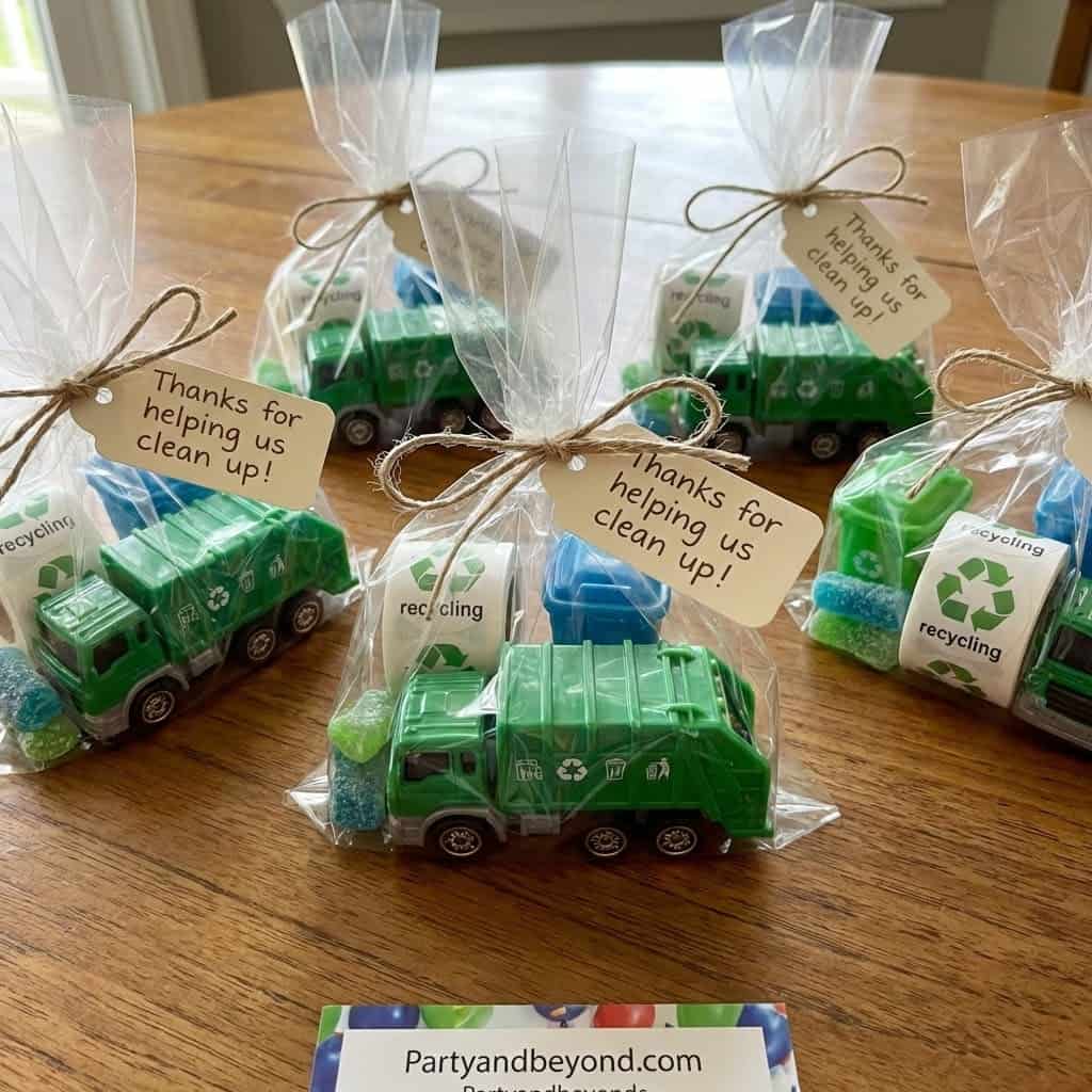 Recycled trash truck party favors with thank you tags for kids' birthday celebration.