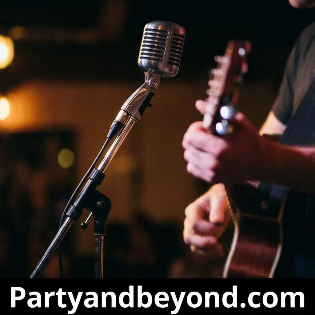 Microphone and guitar at a lively house party.