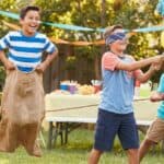 23 Ultimate Party Games for Boys: Fun and Exciting Ideas Kids playing tug-of-war at a birthday party with balloons and decorations.
