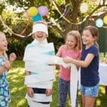 20 Hilarious Birthday Party Games For Kids That Guarantee Non-Stop Laughter Children playing fun birthday party game outdoors.