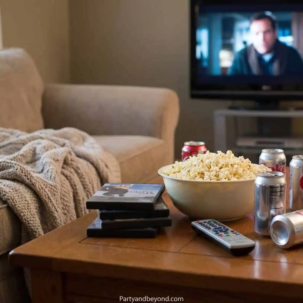Cozy living room with popcorn, soda, and TV for a graduation celebration.