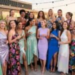 16 Grad Party Dress Ideas 2026: Stand Out in Style Group of women celebrating at a party on a rooftop terrace.