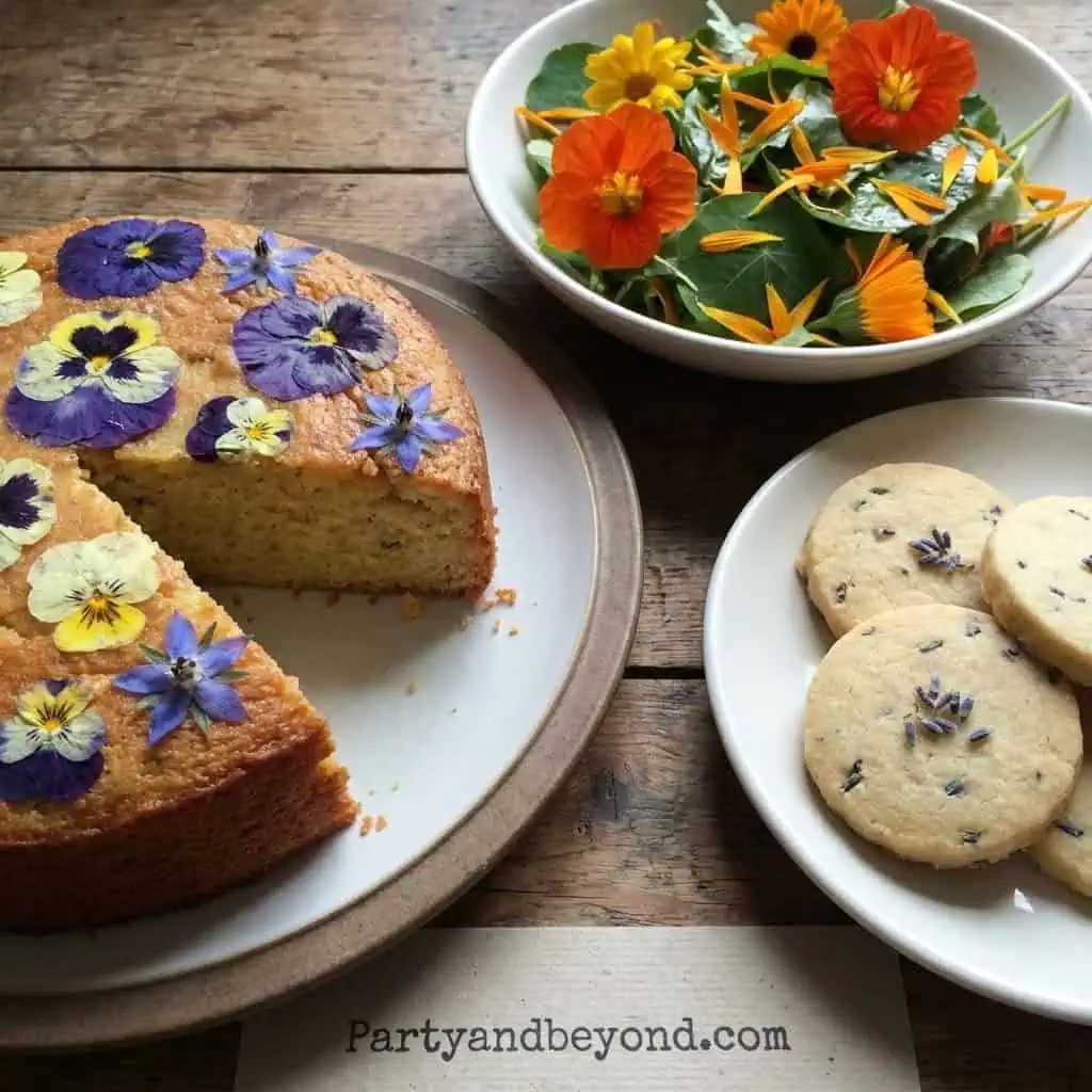 Beautiful flower-themed birthday cake with edible flowers and cookies for a festive celebration.