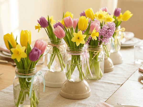 Beautiful tulip bouquets in glass jars for Easter table decor.