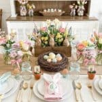 15 DIY Easter Table Decorations on a Budget (Easy and Stunning) Beautiful Easter table setting with pastel flowers and decorated eggs.