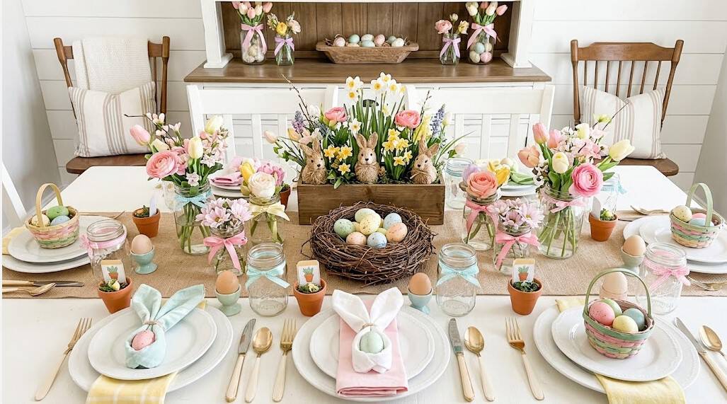 Beautiful Easter table setting with pastel flowers and decorated eggs.