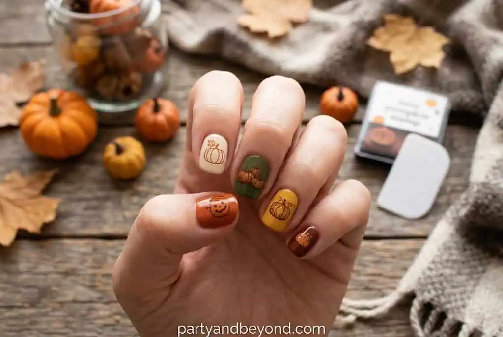 Tiny pumpkin stamped nail art designed for short natural nails.