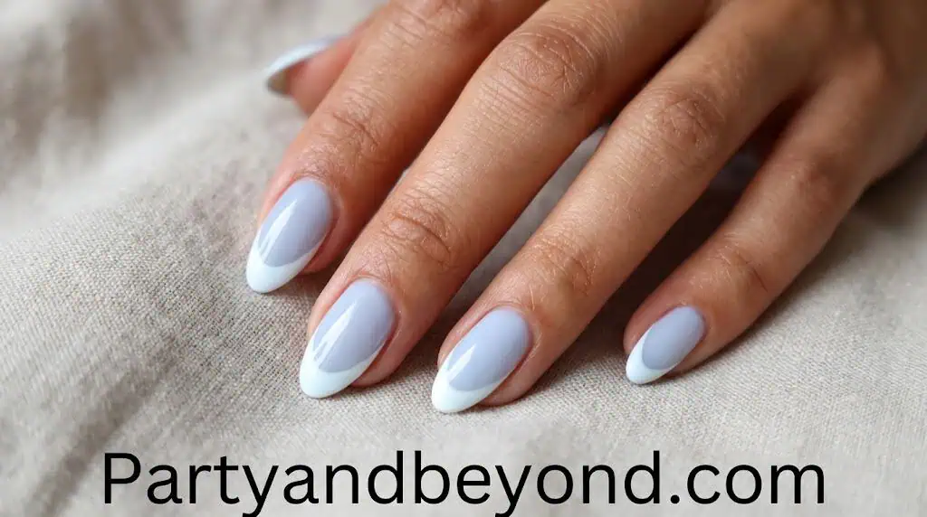 Soft blue nails with white French tips creating a light and elegant patriotic summer look.
