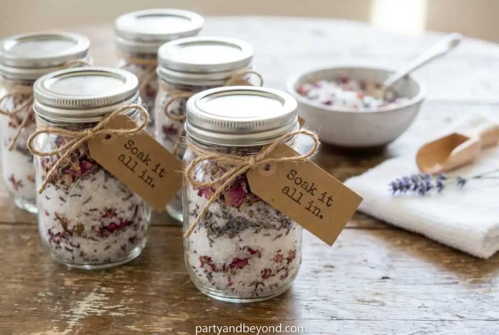 Mason jars filled with lavender bath salts decorated with twine and tags