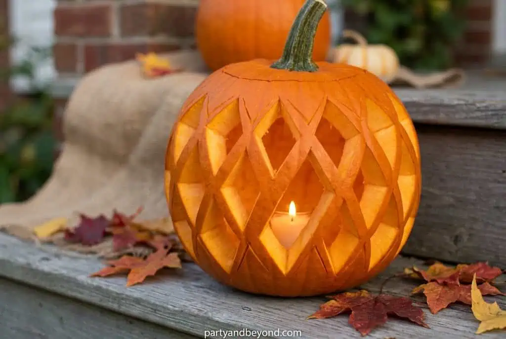 Modern diamond-pattern carved pumpkin with geometric triangle designs.