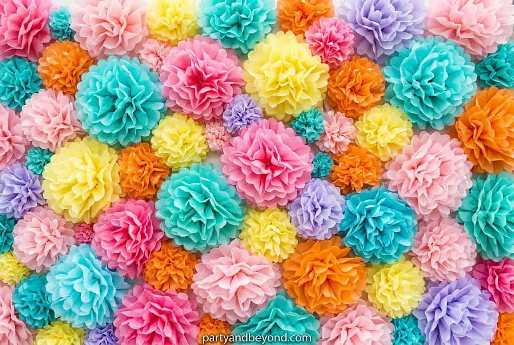 Hanging tissue paper pom-poms in school colors used as indoor graduation decoration