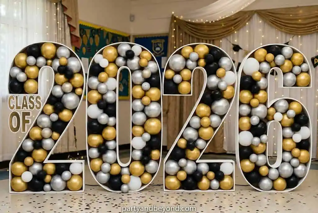 Large balloon mosaic numbers display spelling “Class of 2026” for graduation party backdrop