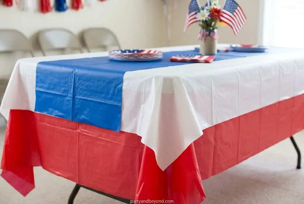 Layered red white and blue tablecloth setup for a patriotic party table