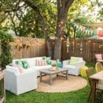 25 Summer Party Decoration Ideas for Your Backyard (2026 Guide) Outdoor summer party setup with string lights, colorful balloons, and garden furniture in a backyard.