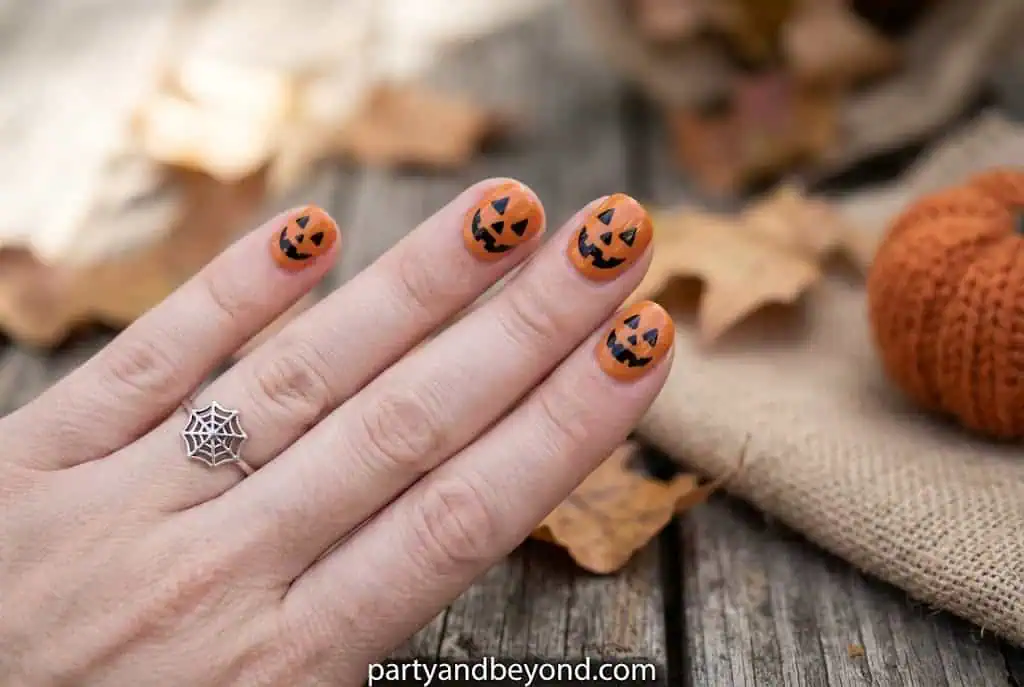 Deep burgundy fall nails with elegant burnt orange pumpkin art.