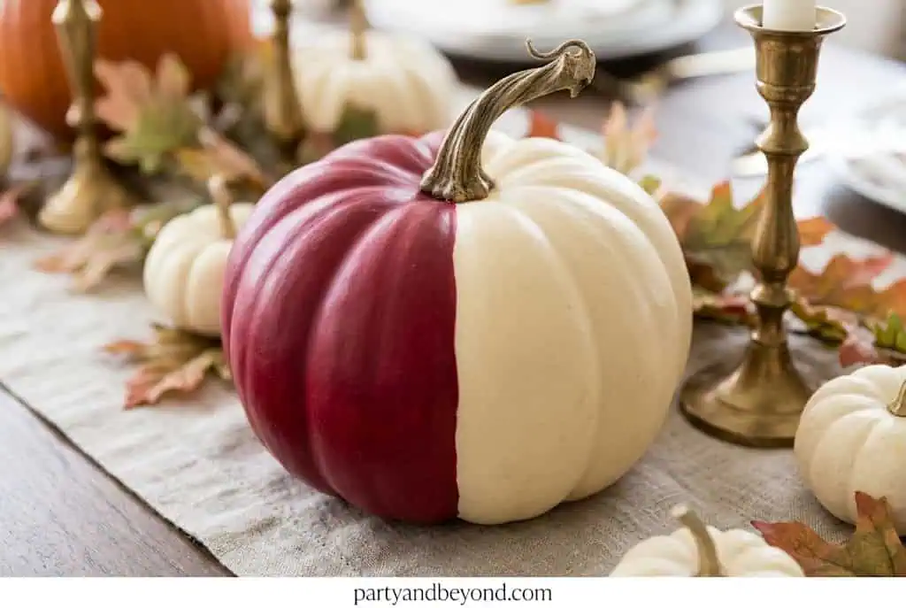Pumpkin split vertically into cranberry red and cream halves