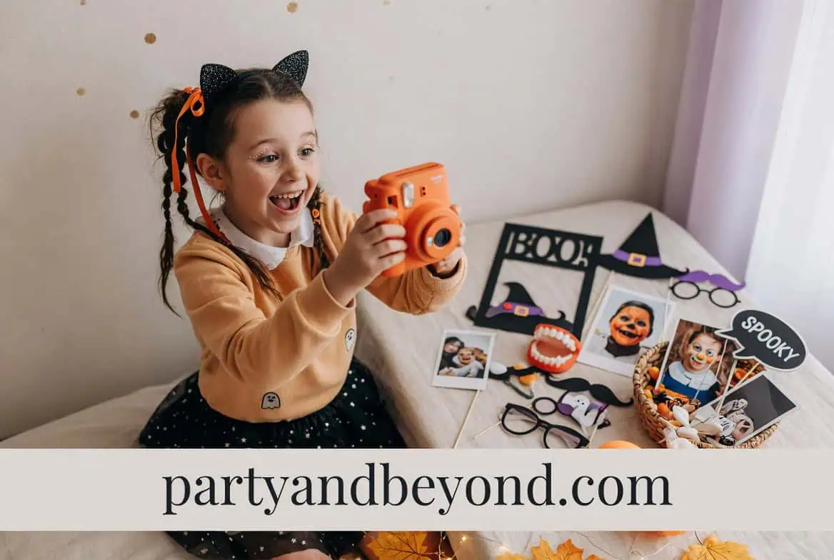 Happy girl with camera at Halloween party with spooky decorations and photo props.