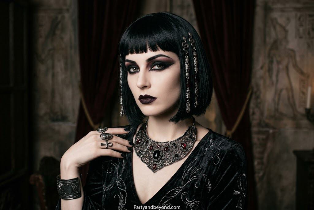 Gothic Cleopatra Halloween makeup with gold eyeshadow, heavy kohl eyeliner, and dark lips