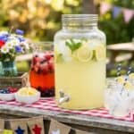 July 4th Drink Station: Best Way to Set Up a Lemonade and Drink Station for Your Party Outdoor July 4th drink station with lemonade, berry-infused water, and patriotic decorations.