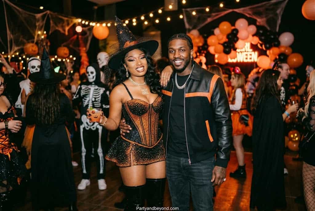 Black couple in hot pink Halloween costumes inspired by Megan Thee Stallion and Pardi.