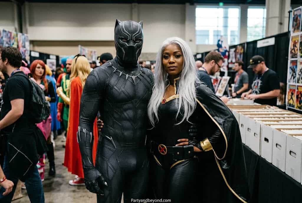 Dramatic Marvel couple costume with Storm white cape and Black Panther suit.