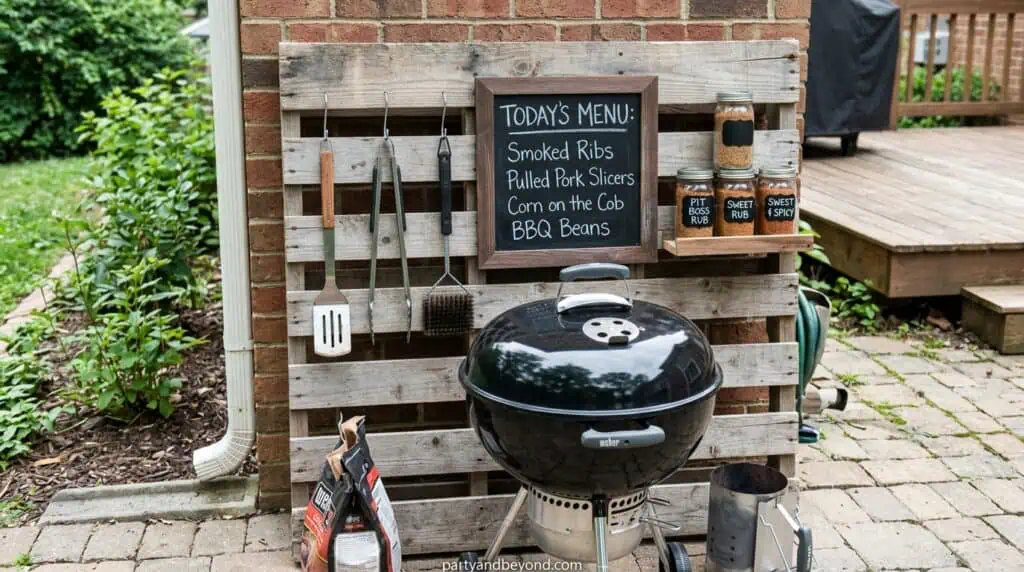 Grill station with hanging BBQ tools and rustic wooden backdrop display