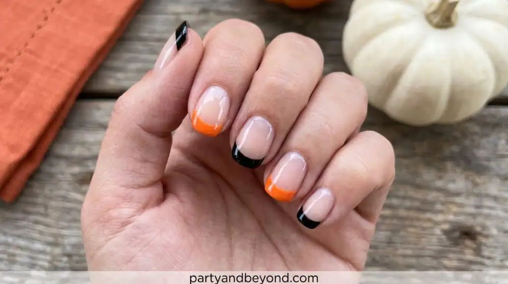 A Halloween-inspired twist on classic French tips using black and orange colors. Thin, clean lines create a stylish and simple festive look suitable for beginners.
