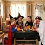 23 Halloween Party Ideas for Kids at Home (Ages 4–12, Full Party Plan) Children in costumes enjoying Halloween party with decorations and treats.