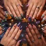 31 Halloween Nail Ideas for 2026 (Easy to Spooky + How to Do Them) Elegant Halloween-themed nail art with colorful designs and accessories.