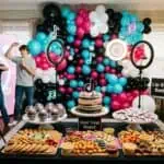 19 TikTok Birthday Party Ideas (Decor, Food & Challenges) Vibrant balloon backdrop with party snacks and entertainment for kids' celebration.