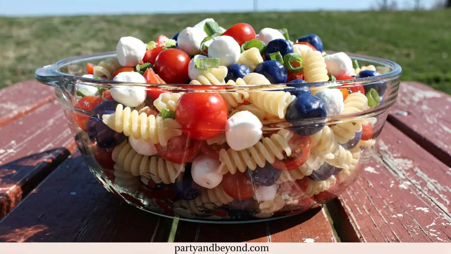 Red white and blue pasta salad with tomatoes mozzarella and blueberries
