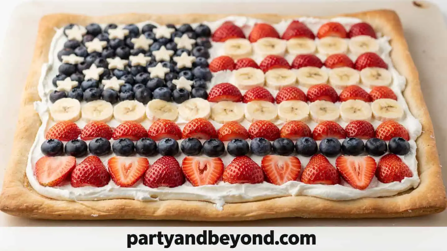 American flag fruit pizza decorated with strawberries and blueberries