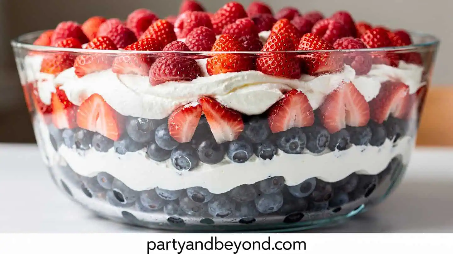 Red white and blue berry trifle layered with cake whipped cream and berries