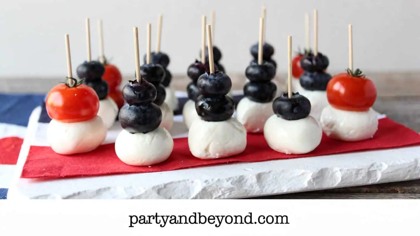 Patriotic caprese bites with strawberries mozzarella basil and tomatoes