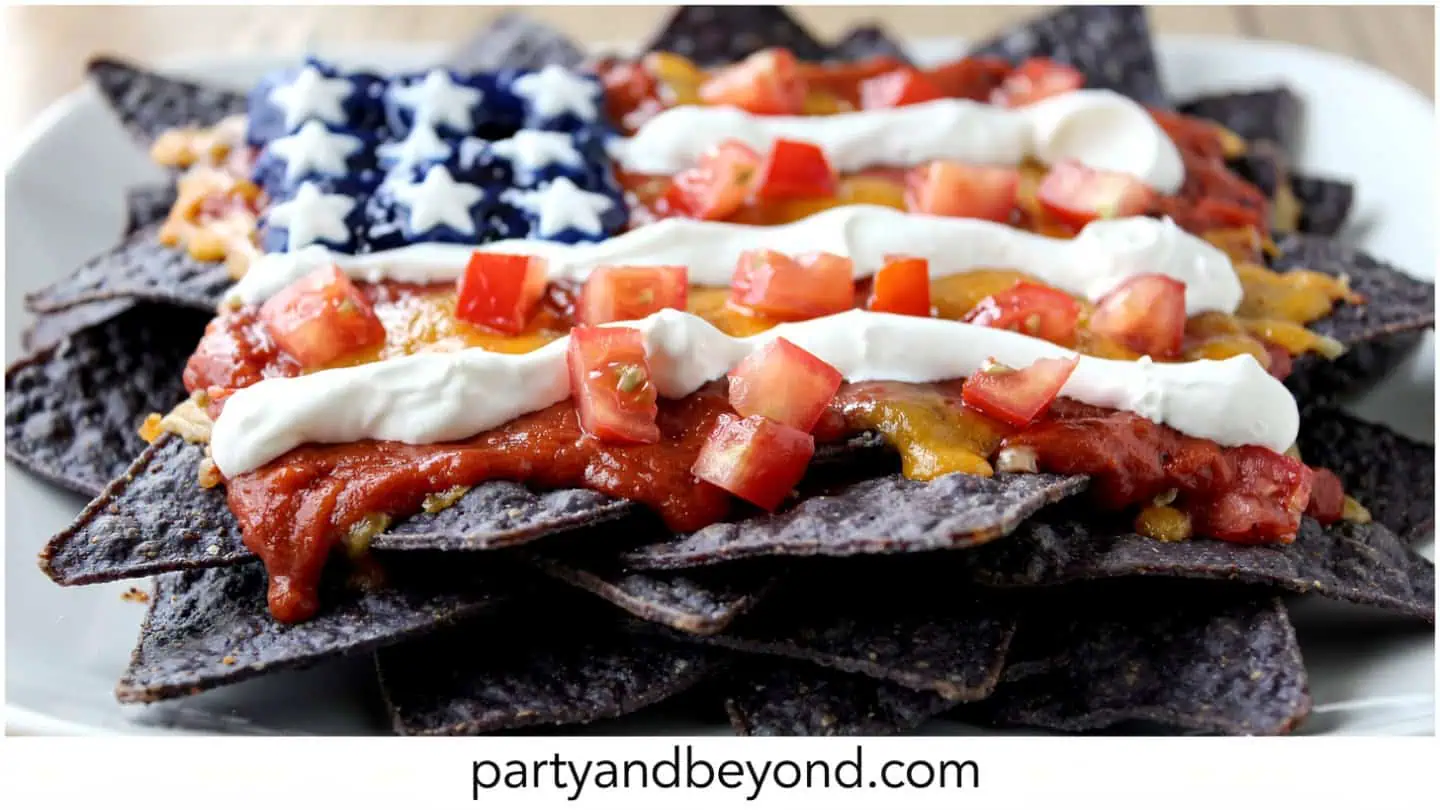 Loaded patriotic nachos with blue corn chips queso and salsa