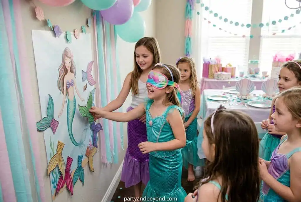 Mermaid-themed version of pin the tail game with colorful mermaid tails.