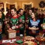 Ugly Christmas Sweater Party Ideas: Games, Food, Awards & Everything That Actually Works Festive holiday punch bowl with cranberry punch, fruit, and Christmas drink decorations.
