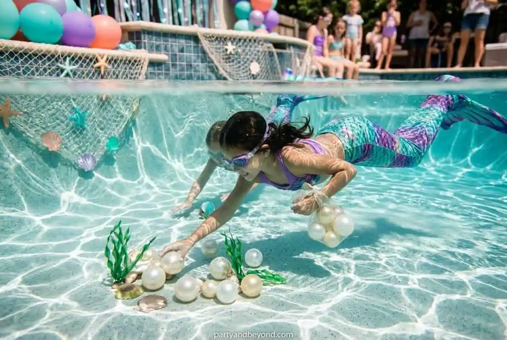 Kids searching for hidden pearls in a sensory bin filled with colorful balls.
