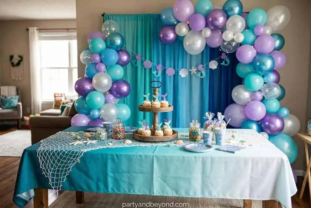 Clear and blue balloon clusters hanging from the ceiling to resemble underwater bubbles.