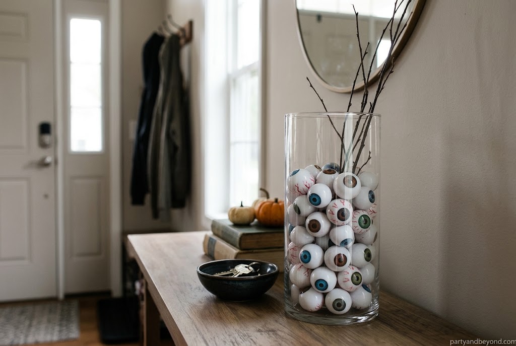 Clear vase filled with black beans and Halloween eyeballs.