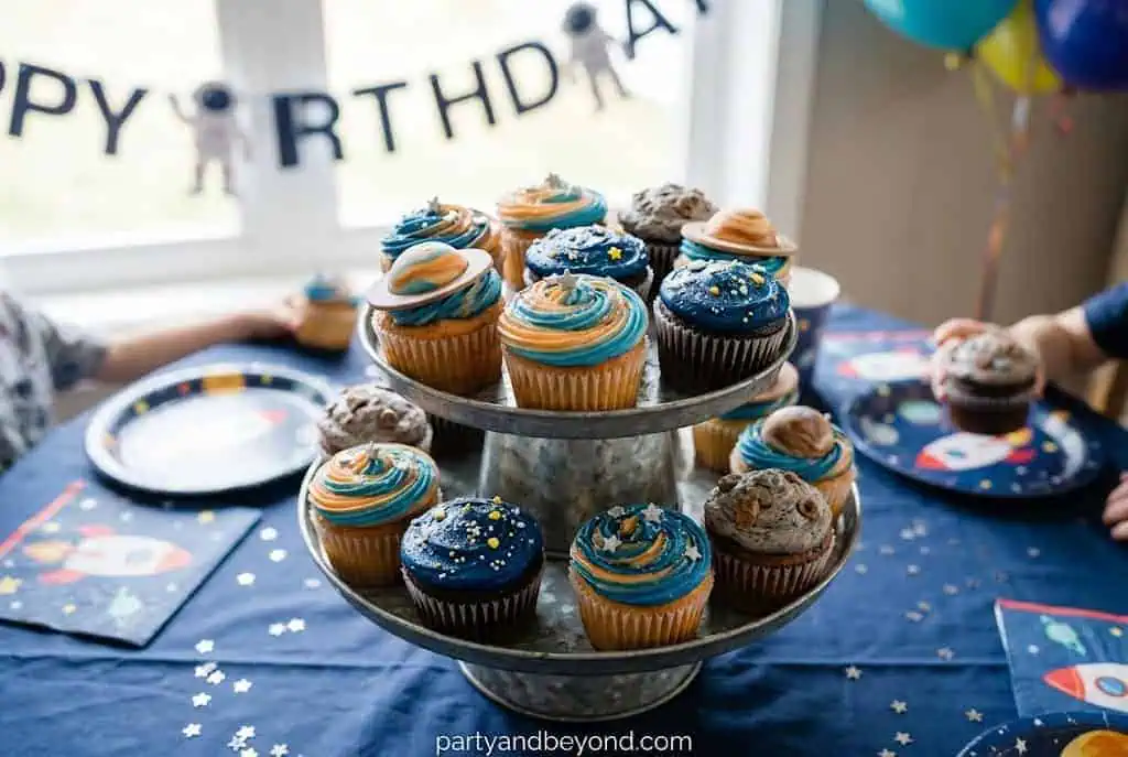 Galaxy-inspired cupcakes decorated with colorful frosting to resemble planets.