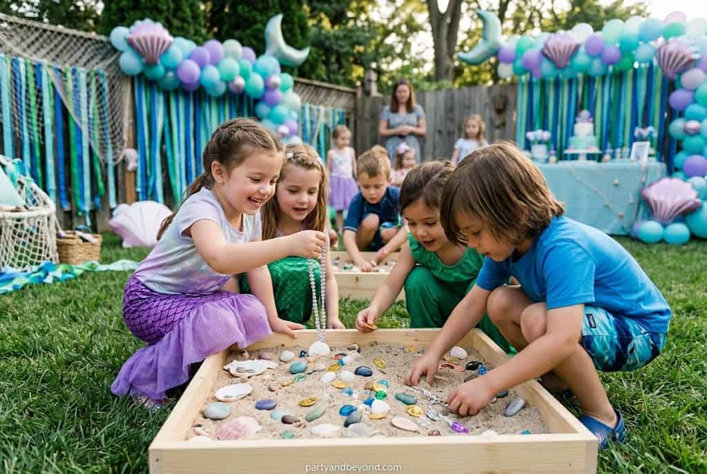 Children searching for hidden gold coins and seashell treasures during a mermaid party game.