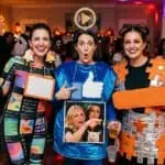 20 Funny Halloween Costumes For Women (That'll Win Every Party in 2026) Group of women enjoying a lively party with colorful costumes and drinks at Party & Beyond! event.