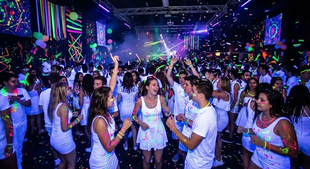 white dress code shirts glowing under blacklight at a neon party